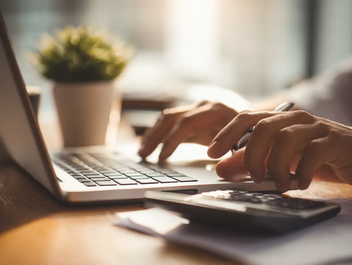 A person organizing digital estate planning documents on a laptop and tablet.