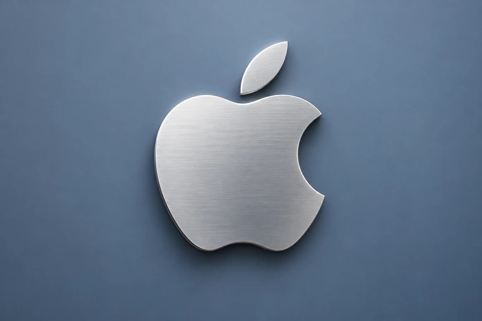 A silver Apple logo against a blue-grey background.